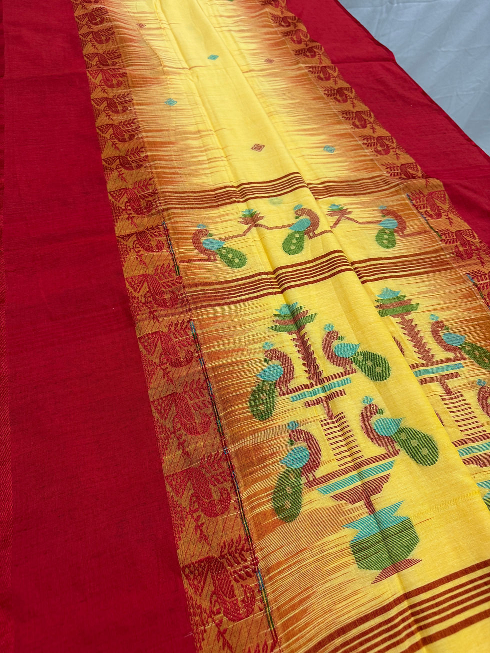 Thumbnail: Yellow and red Bengal handloom soft cotton saree with intricate peacock motifs on the pallu.