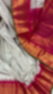 Video of Vidhi white and brown micro-check Gadwal silk saree with a Rani pink border and green salvage detail.