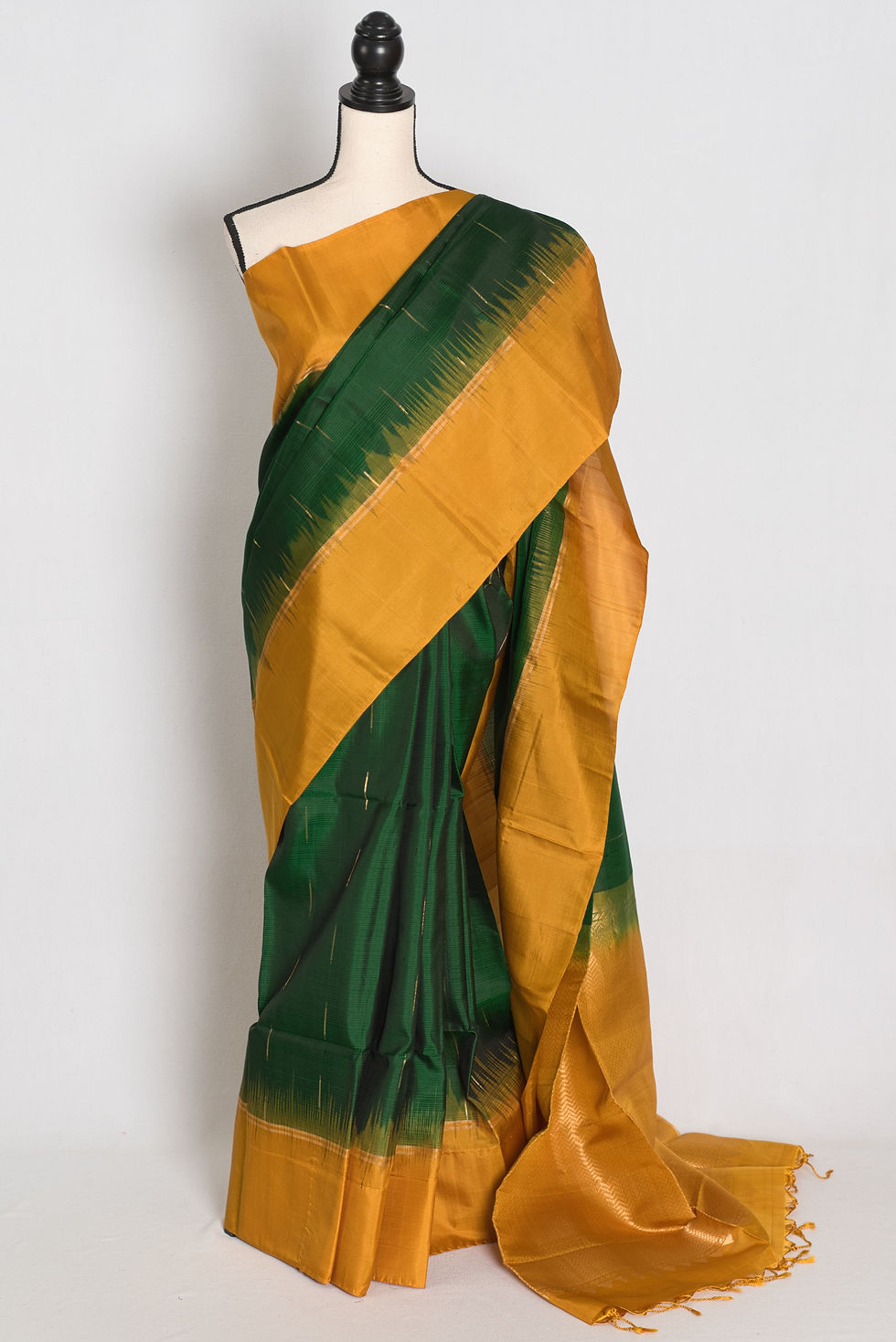 Bottle green Kanjivaram silk saree featuring fine gold zari dashes, a solid chrome yellow border, zari brocade pallu.