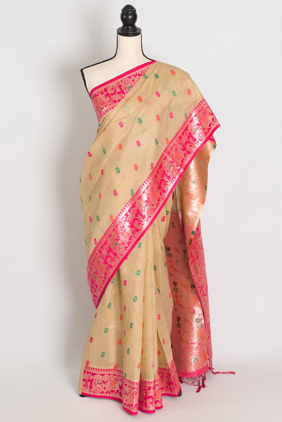 Beige blended cotton Baluchari saree with a vibrant pink border on a mannequin, traditional Bengali look.