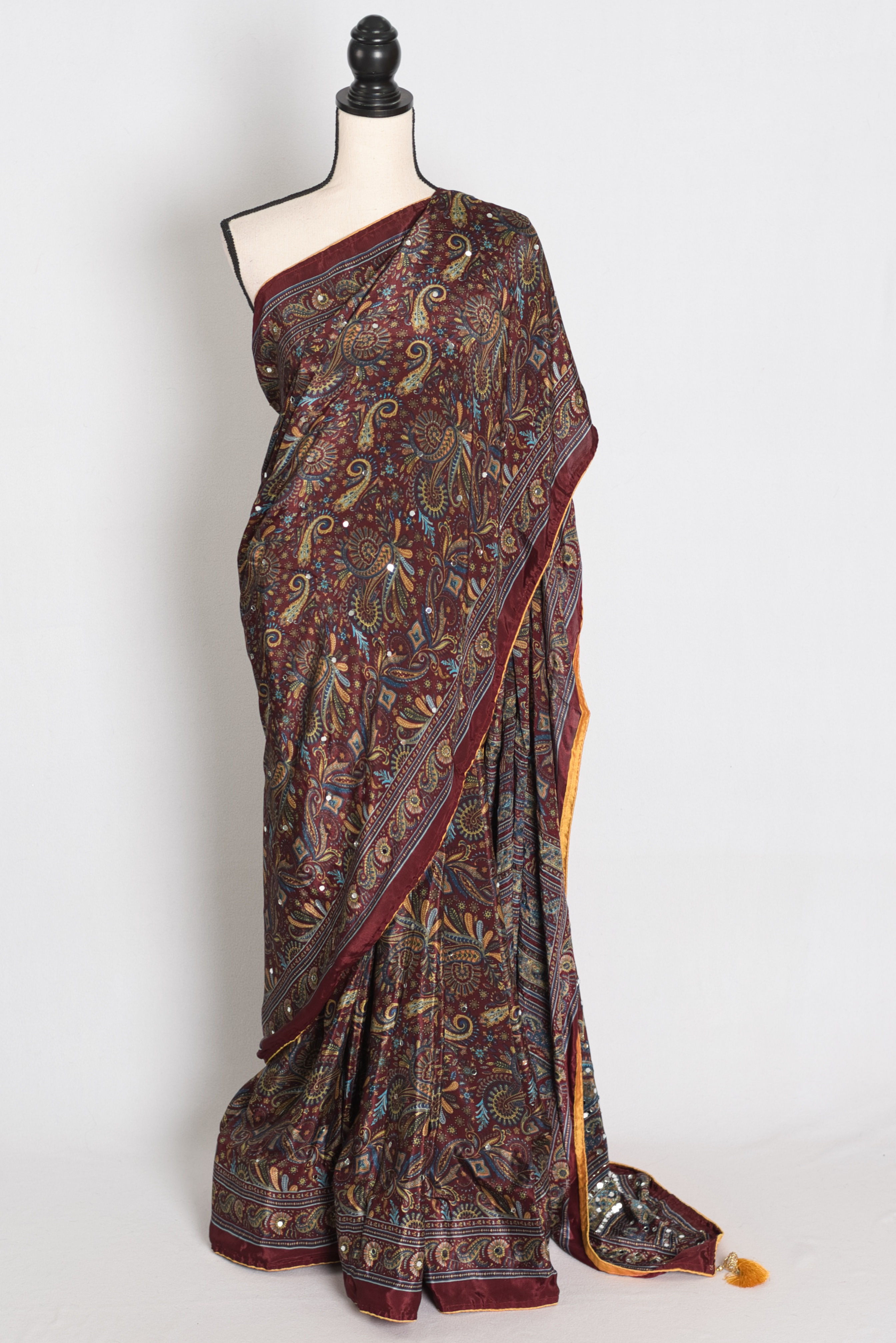 Full length front view of the Rimi brown Kalamkari print semi modal silk saree with hand-pasted mirror embroidery.