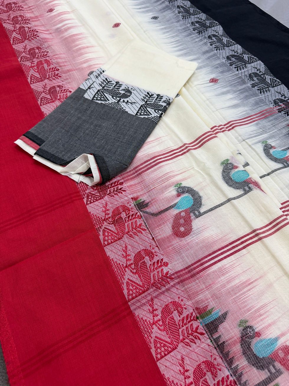 Off-white soft cotton Bengal handloom saree featuring a dual red and black Ganga Jamuna border and peacock motif pallu.