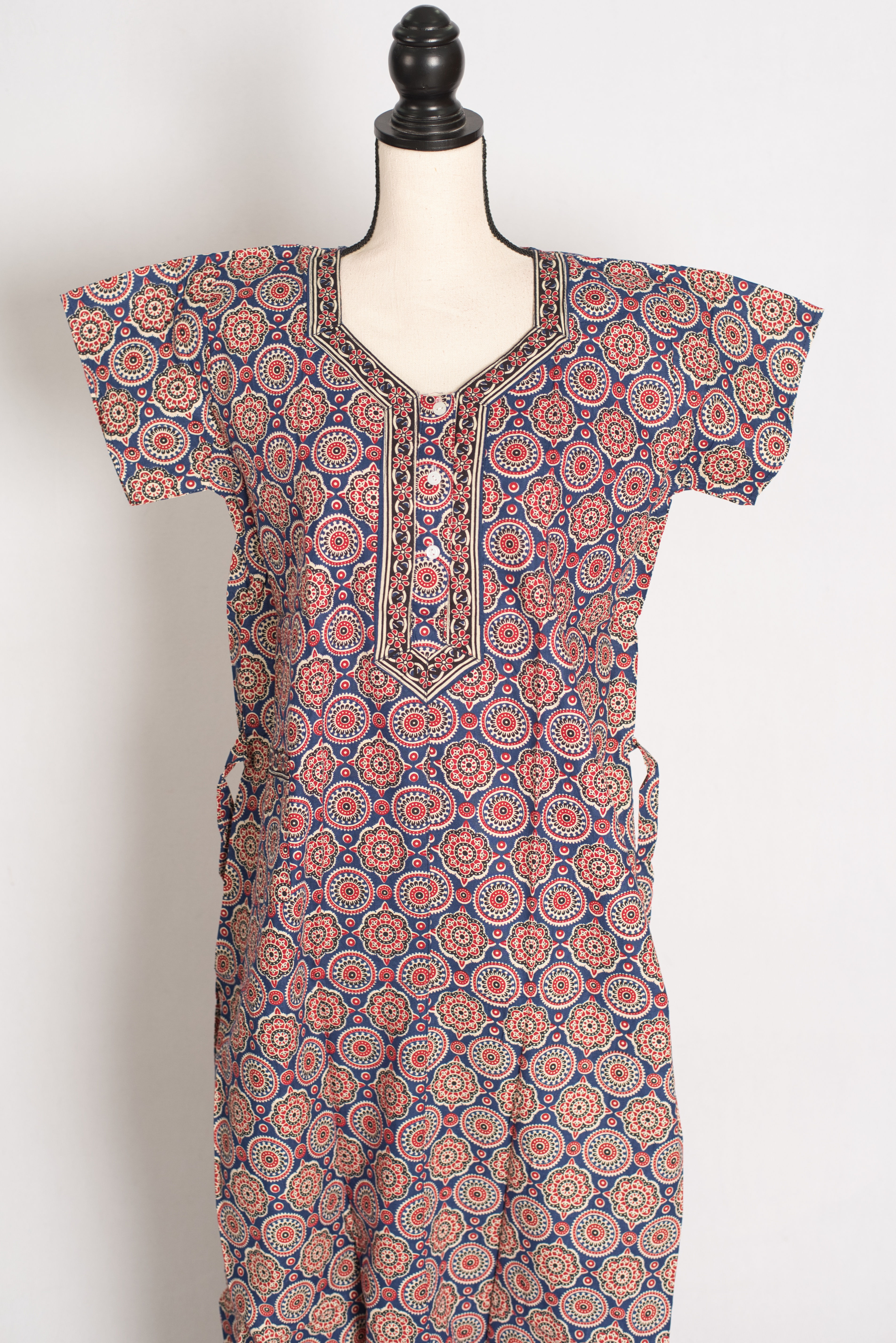 Close-up of the buttoned neckline border and detailed Kalamkari patterns on a 100% cotton greyish blue women's nightgown.