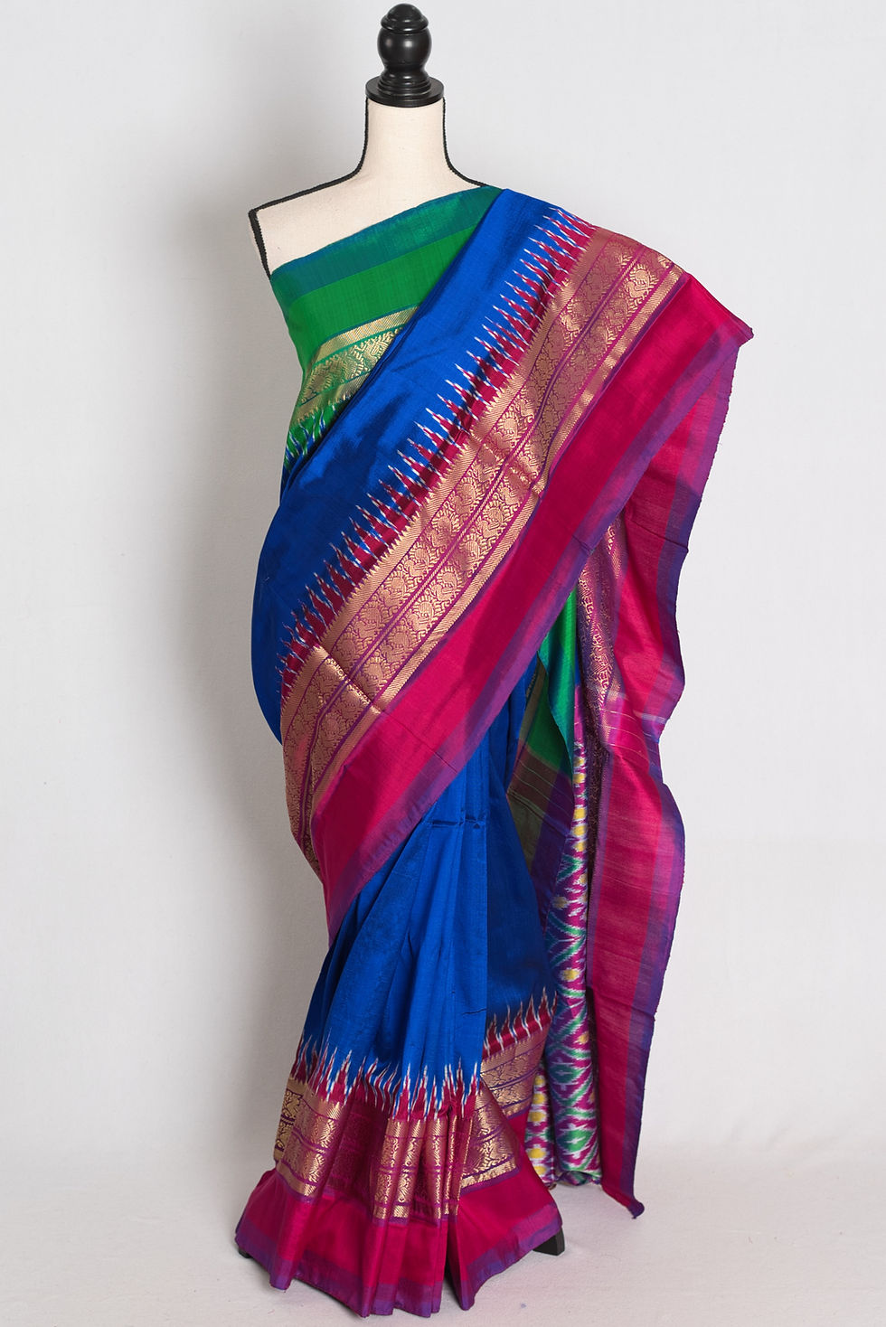 Royal blue handwoven pochampally silk saree with ganga jamuna border draped on mannequin.