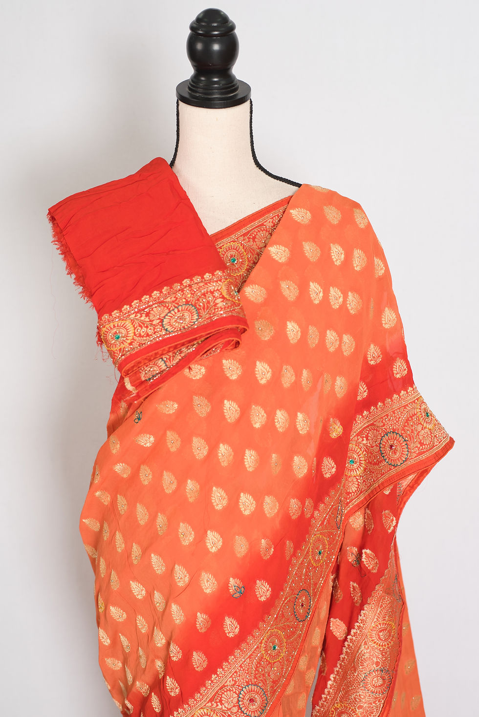 Front full-length view of the orange and red semi khaddi georgette Banarasi saree draped on a mannequin.