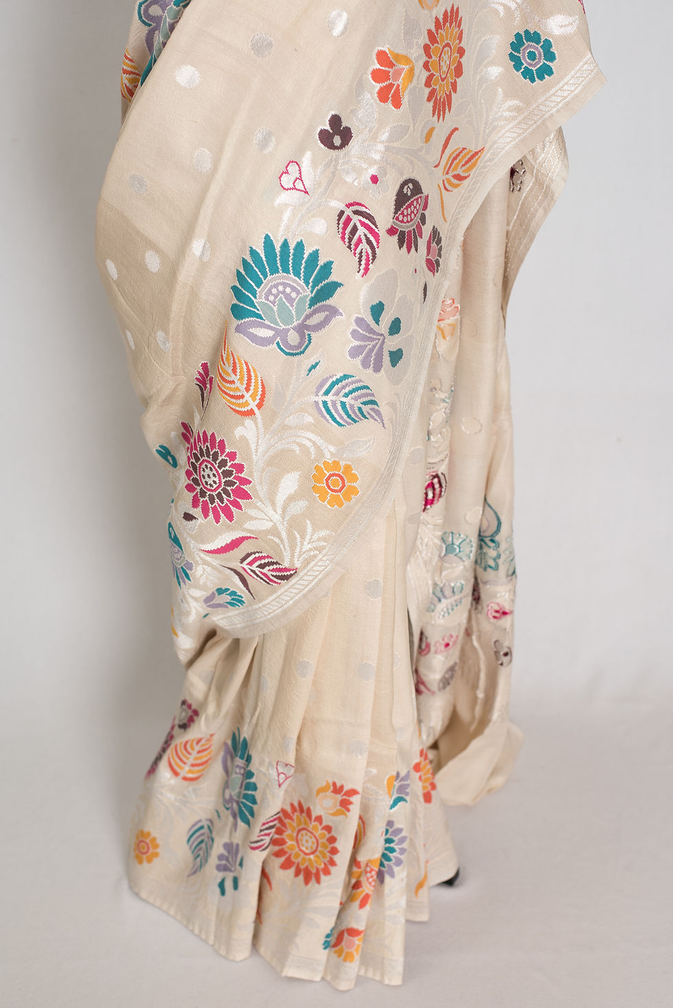Thumbnail: Beige and silver polka dot Tussar Georgette Banarasi saree featuring a vibrant Paithani-inspired floral Minakari border.