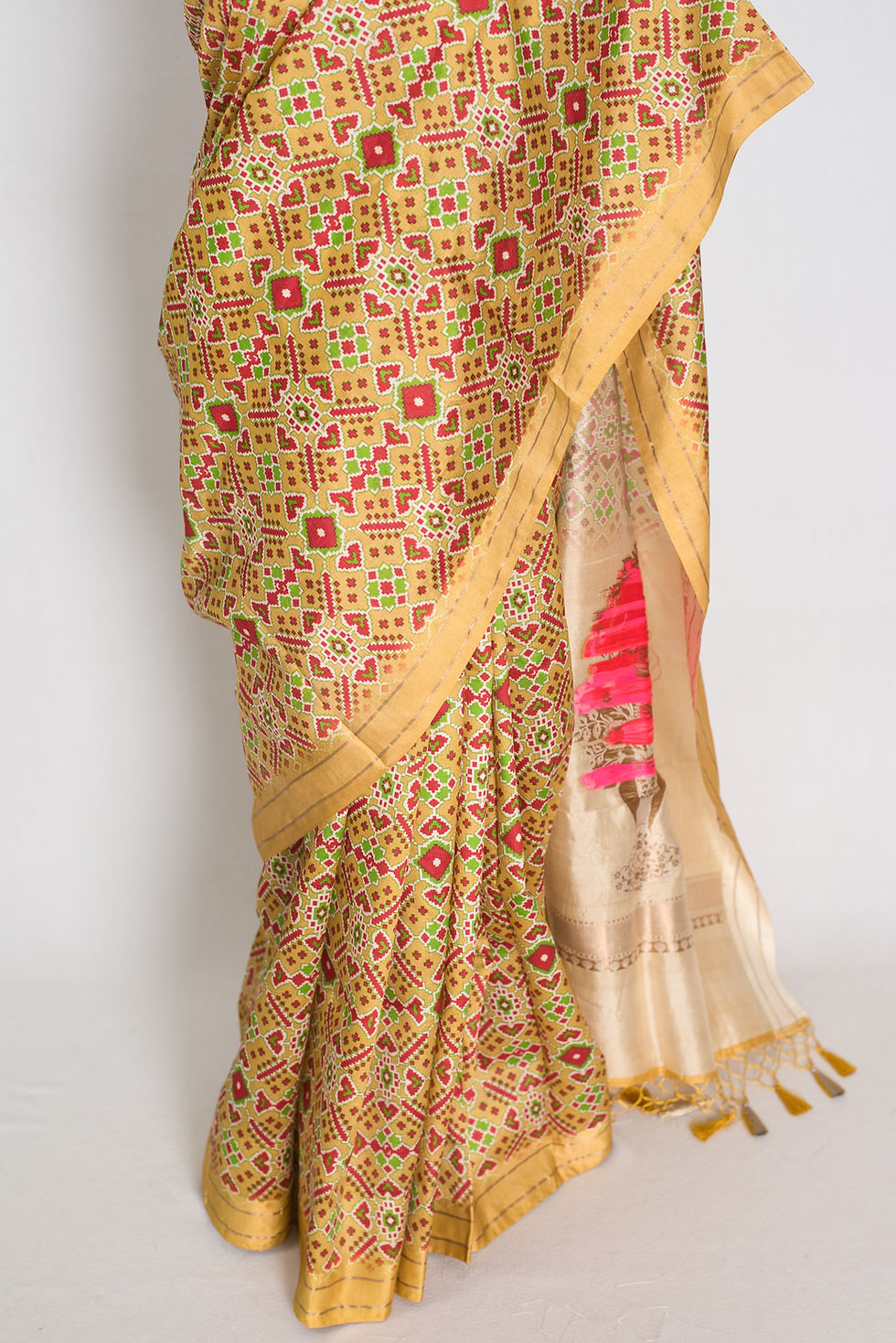 Thumbnail: yellow and gold pure banarasi katan silk saree featuring patola style ikkat print on a full mannequin drape.