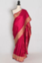 Rose pink semi mashru Banarasi saree draped on a mannequin displaying its all-over gold zari butis.