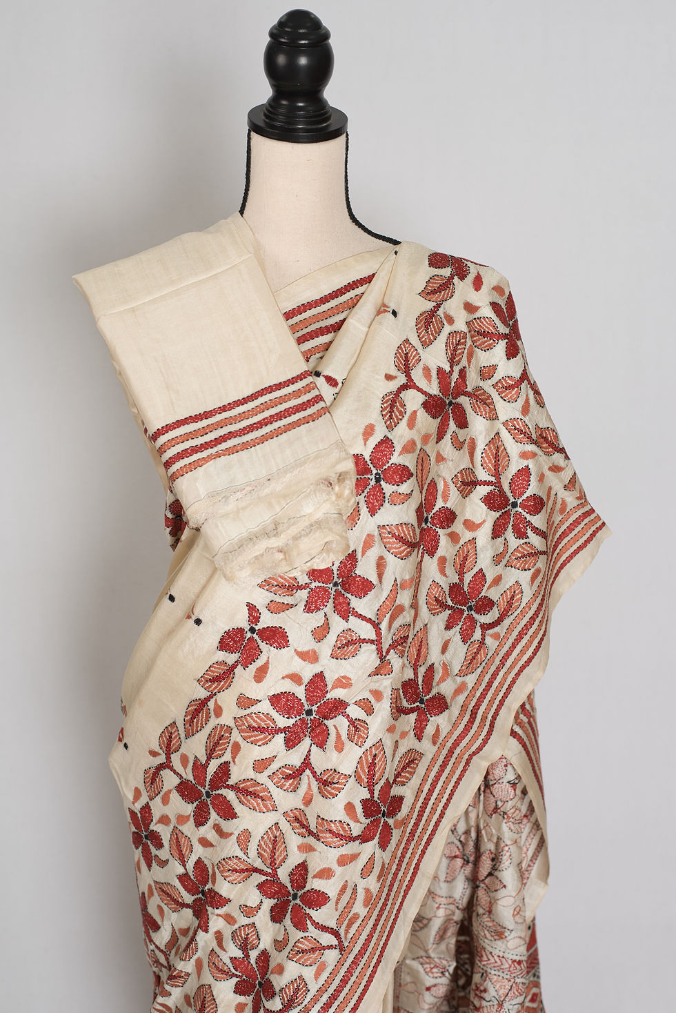 Thumbnail: Cream pure Bangalore silk saree with rust brown hand-embroidered Kantha stitch floral vines draped on a mannequin.