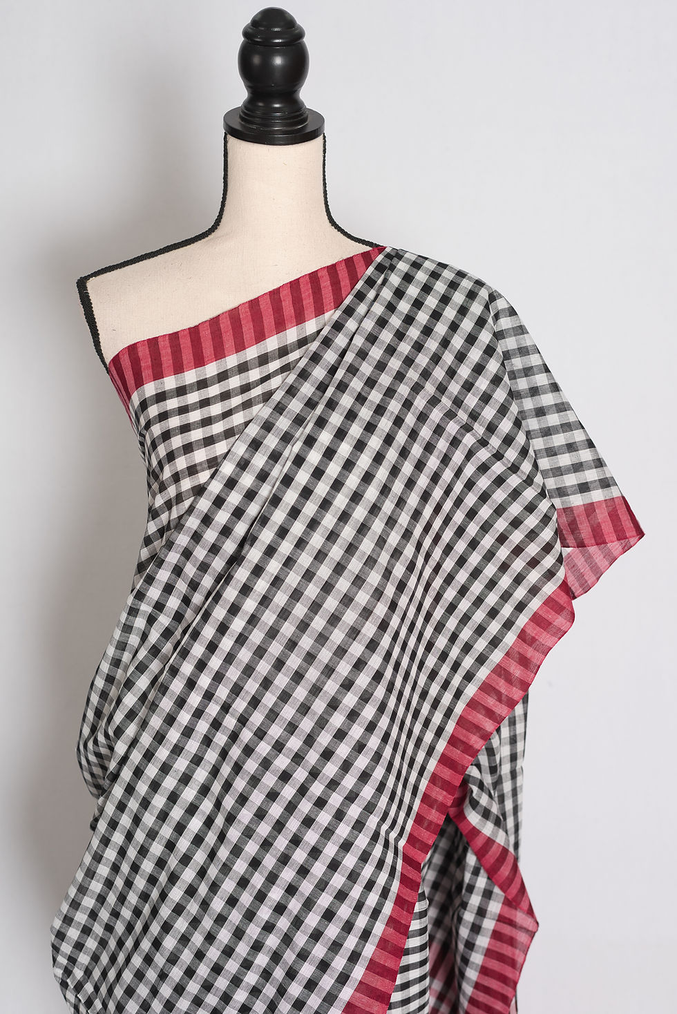 Thumbnail: White and Black Gamcha Checks Soft Cotton Dhaniakhali Saree draped elegantly on a mannequin showcasing its red border.