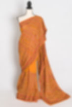 Full length front view of the Nirja orange georgette saree featuring dense all-over Kashmiri machine embroidery.