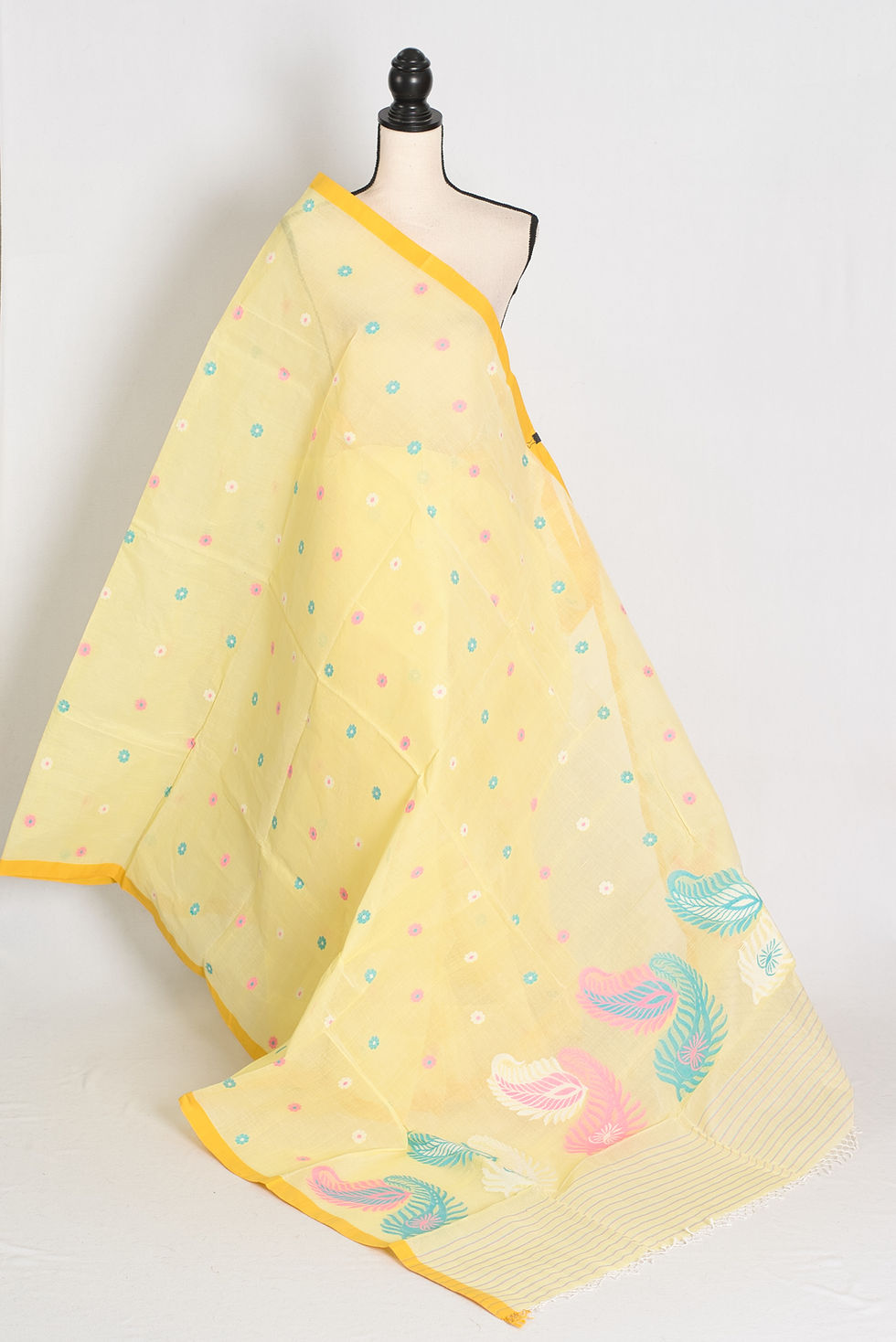 Light yellow Bengal handloom cotton Jamdani saree with multicolored floral motifs and paisley border, shown on mannequin.