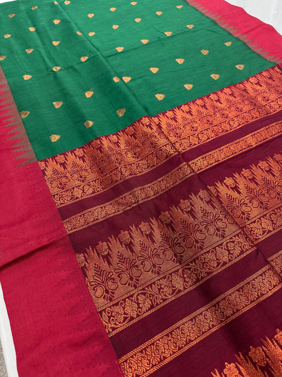 Dark green and maroon blended cotton Gadwal saree featuring intricate copper zari borders.