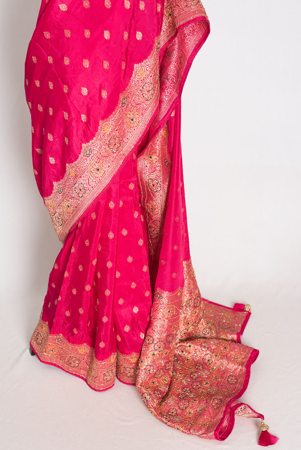 Thumbnail: Hot pink and gold hand embroidered silk saree featuring cutdana border work, detailed pallu, and matching stitched blouse.