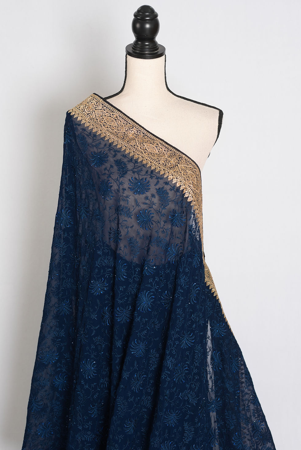Thumbnail: Midnight Blue georgette partywear saree draped on a mannequin.