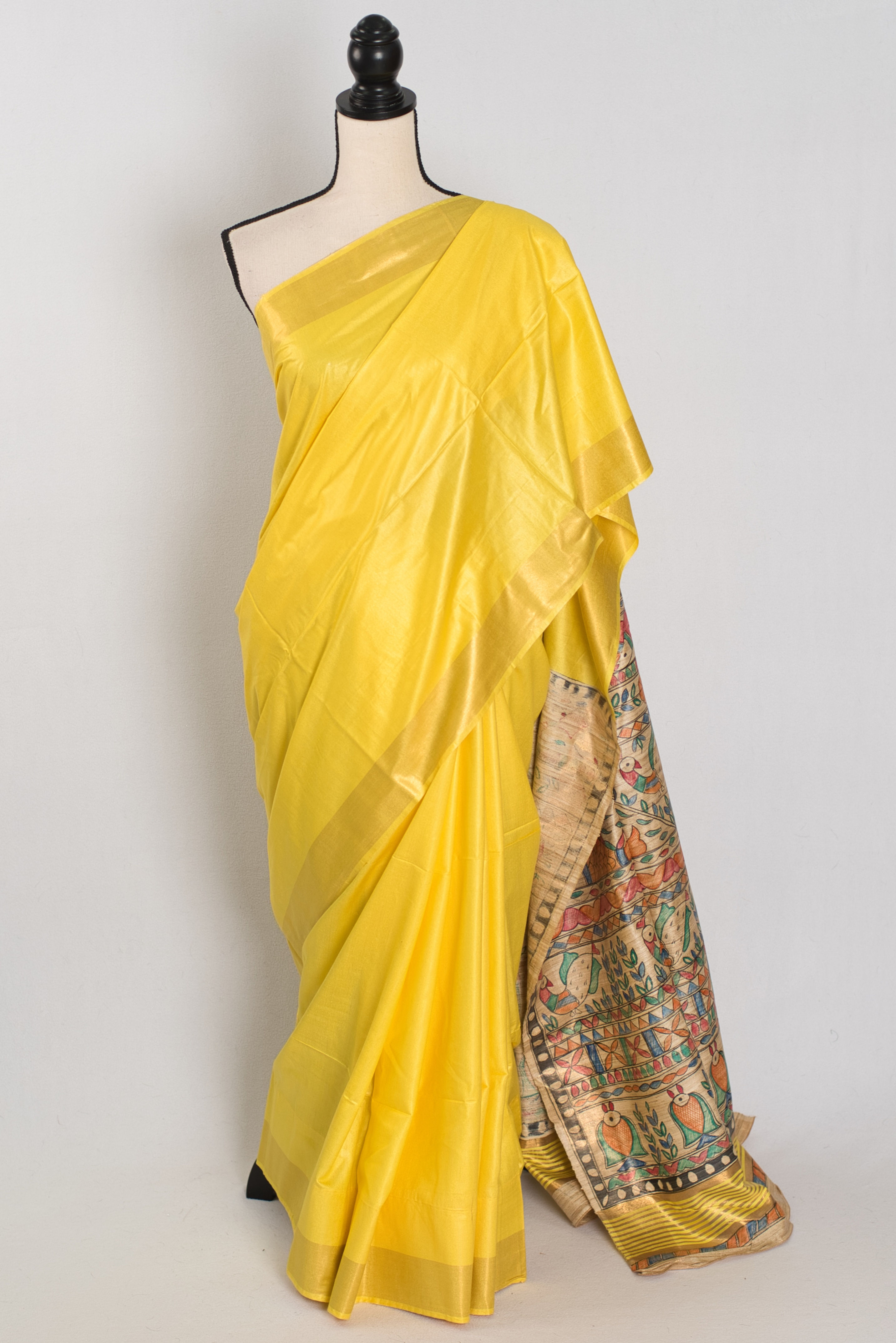 Bright yellow staple Tussar saree with a colorful hand-painted Madhubani pallu (Ragini Collection).