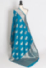 Thumbnail: A mannequin displaying a crimson red semi crepe Banarasi saree with intricate silver zari floral motifs