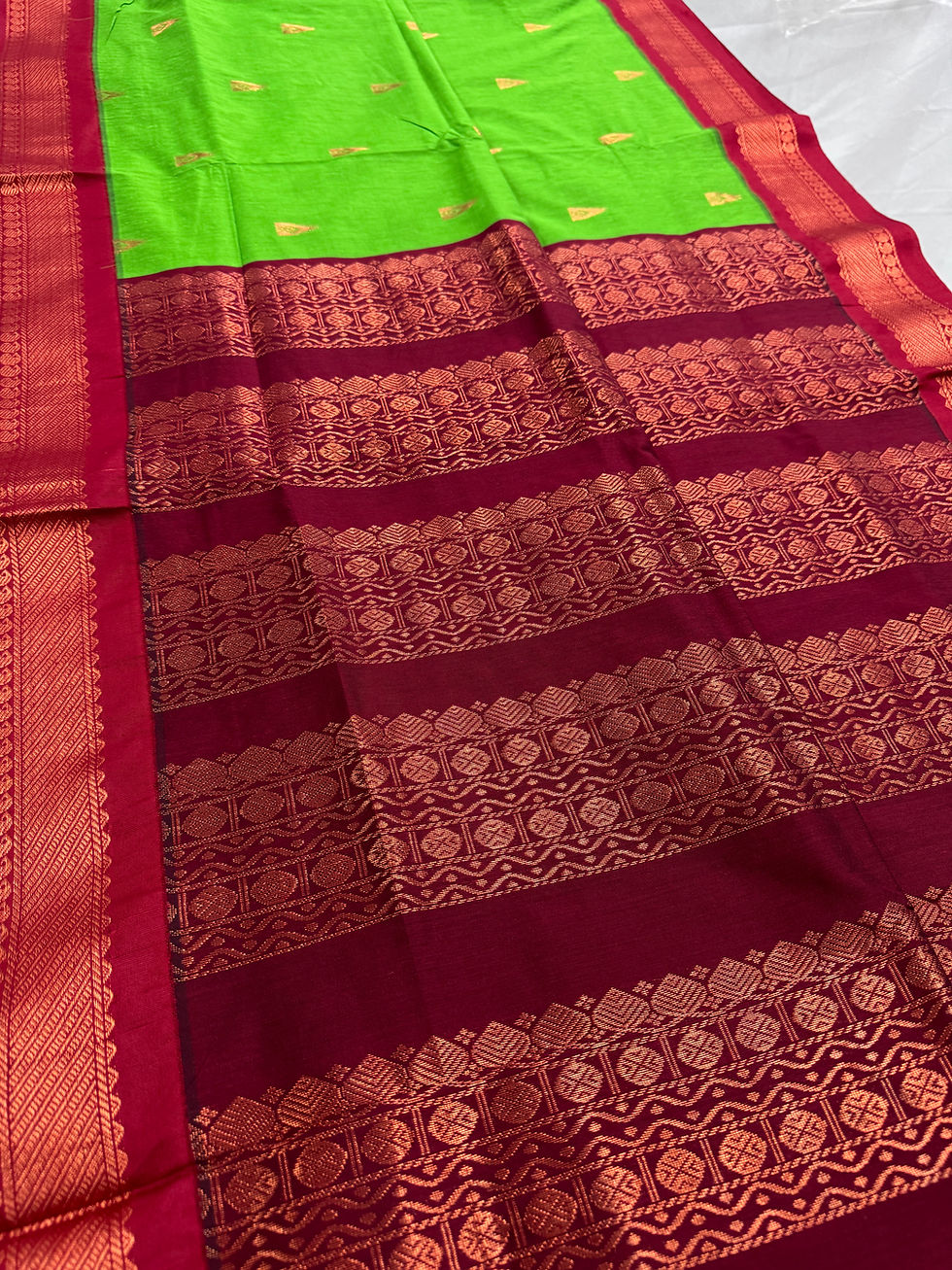 Naaz parrot green blended cotton Gadwal saree showcasing the intricate dark red zari pallu.