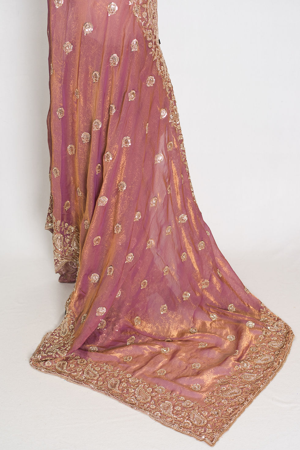 Thumbnail: Soft peach purple organza partywear saree on a mannequin displaying heavy designer embroidery and metallic shimmer finish.