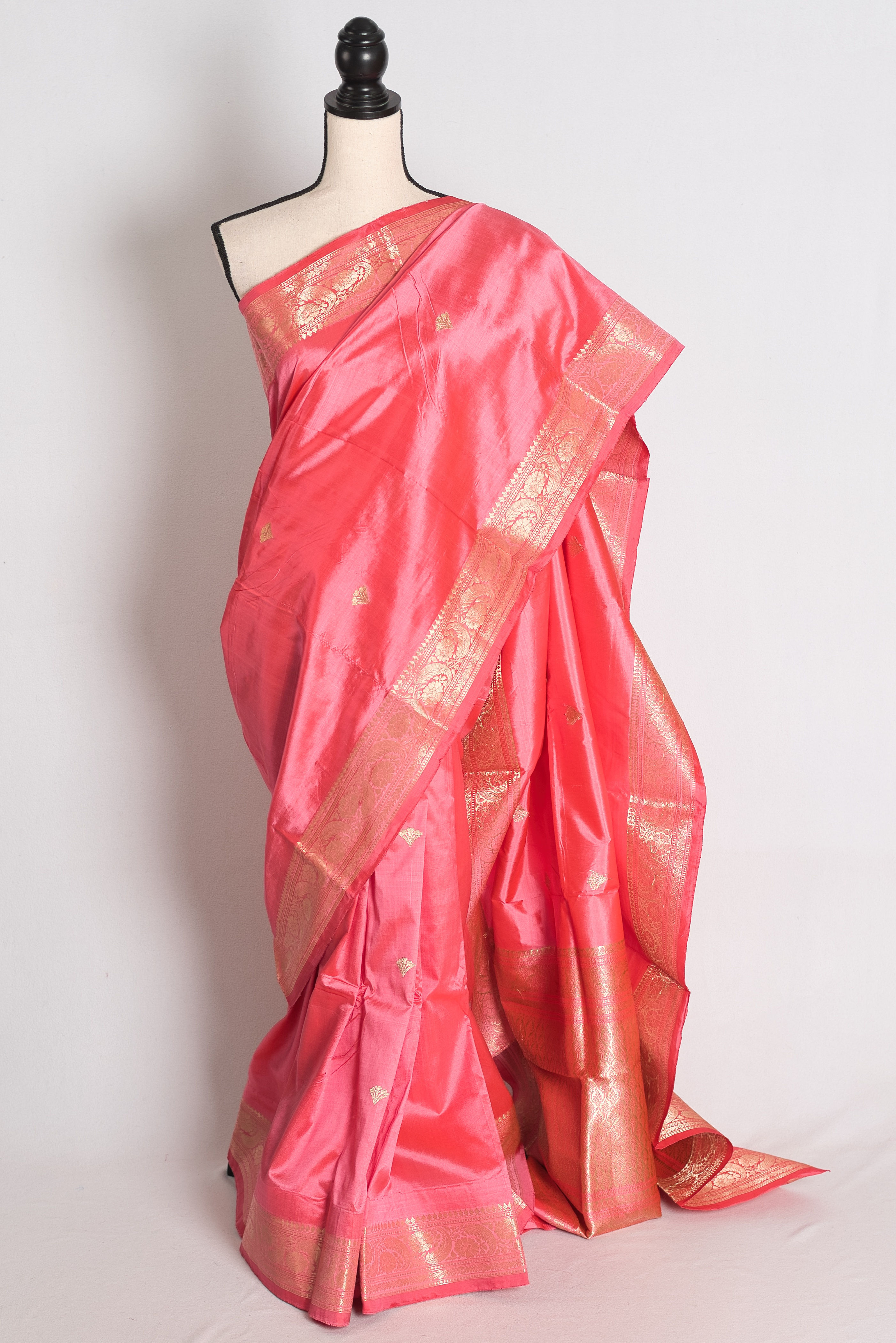 Pink and Gold Katan Silk Banarasi Saree draped elegantly on a mannequin showcasing its rich gold zari borders.