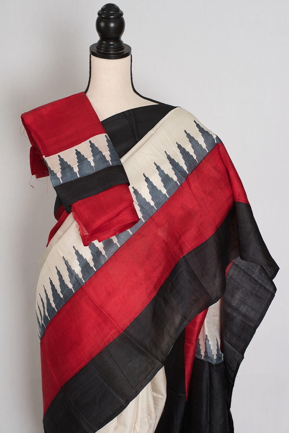 Mohita white, black, and red Murshidabad silk saree with a geometric temple border design draped beautifully on a mannequin.