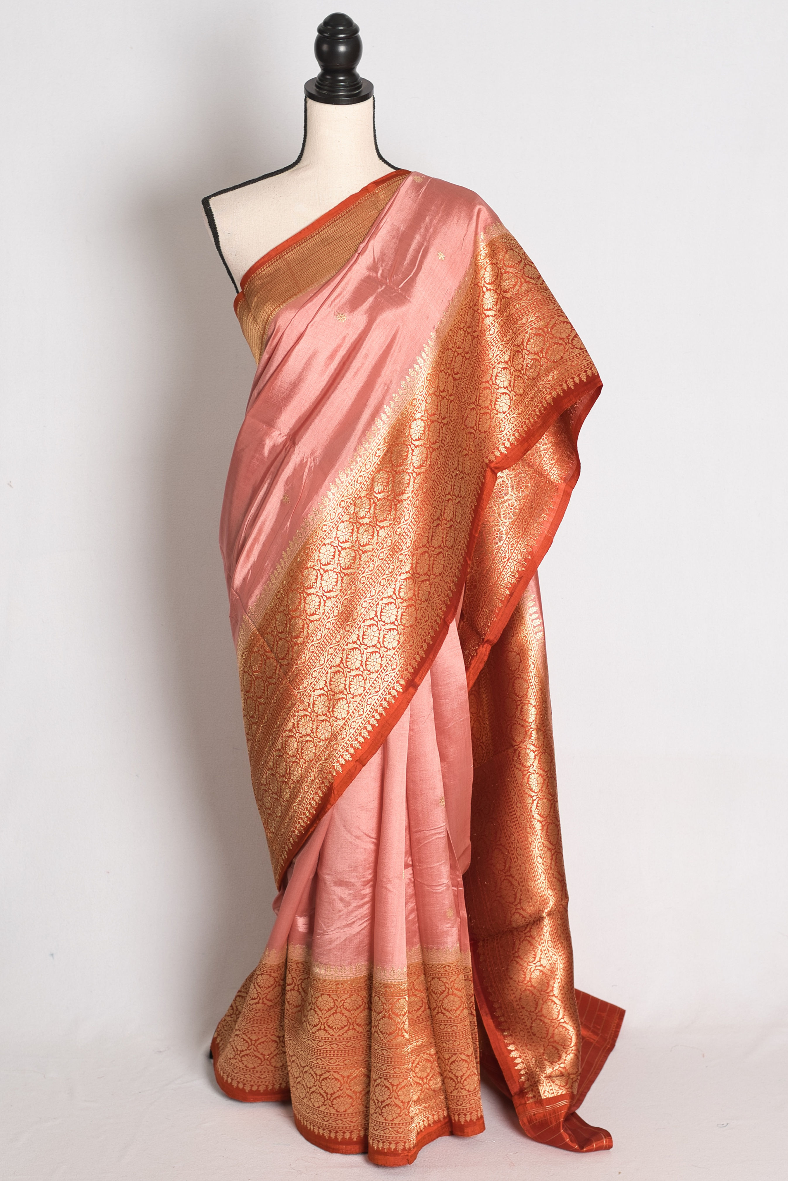 Pastel Brown and Rust Wide Border Raw Mango Silk Banarasi Saree draped elegantly on a mannequin.
