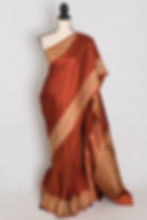 Rust orange semi mashru Banarasi saree draped on a mannequin displaying woven floral border.