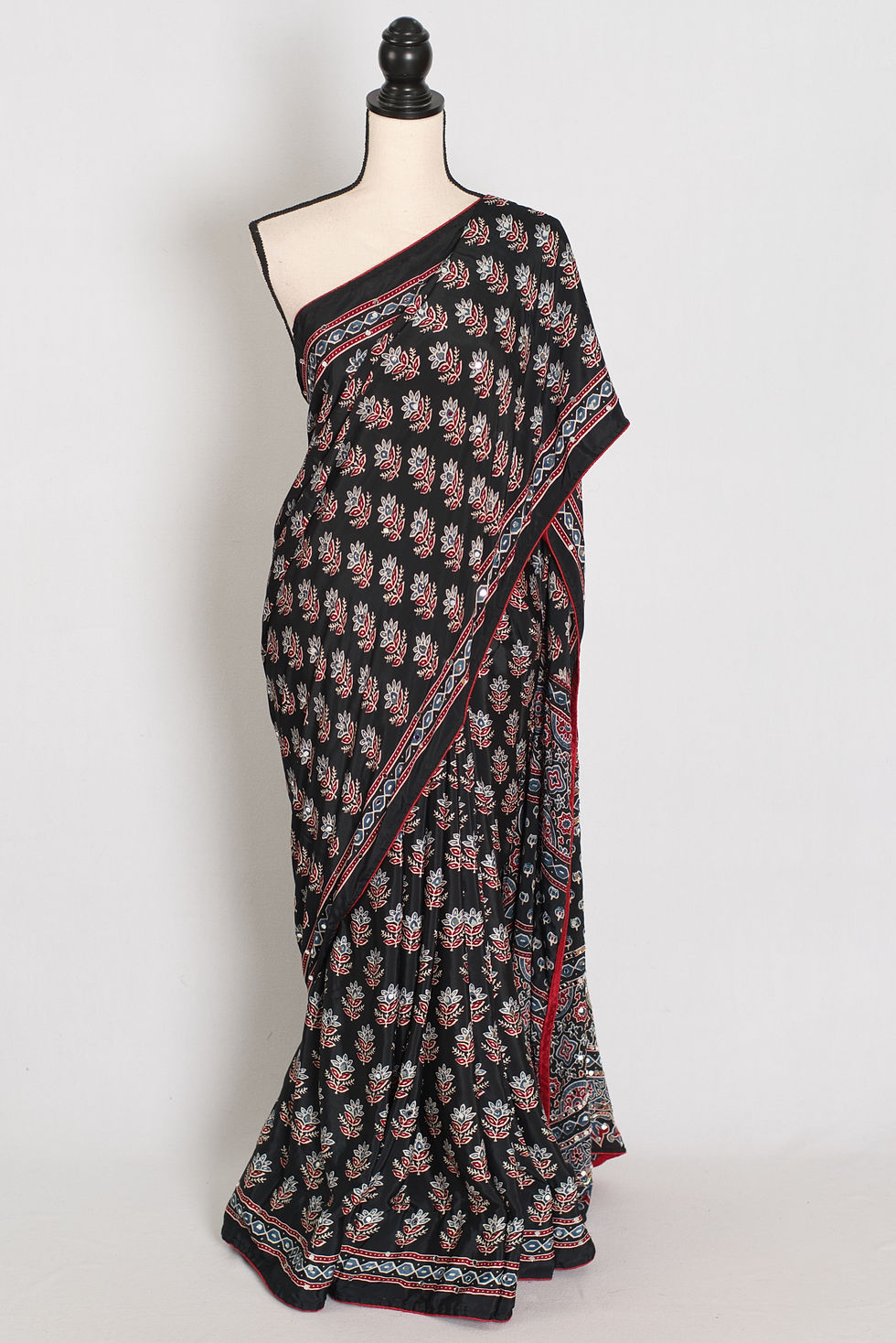 Black semi modal silk partywear saree draped on a mannequin, showcasing mirror work.
