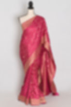 Pink and gold semi silk Banarasi saree draped on a mannequin displaying its all-over gold zari jaal.