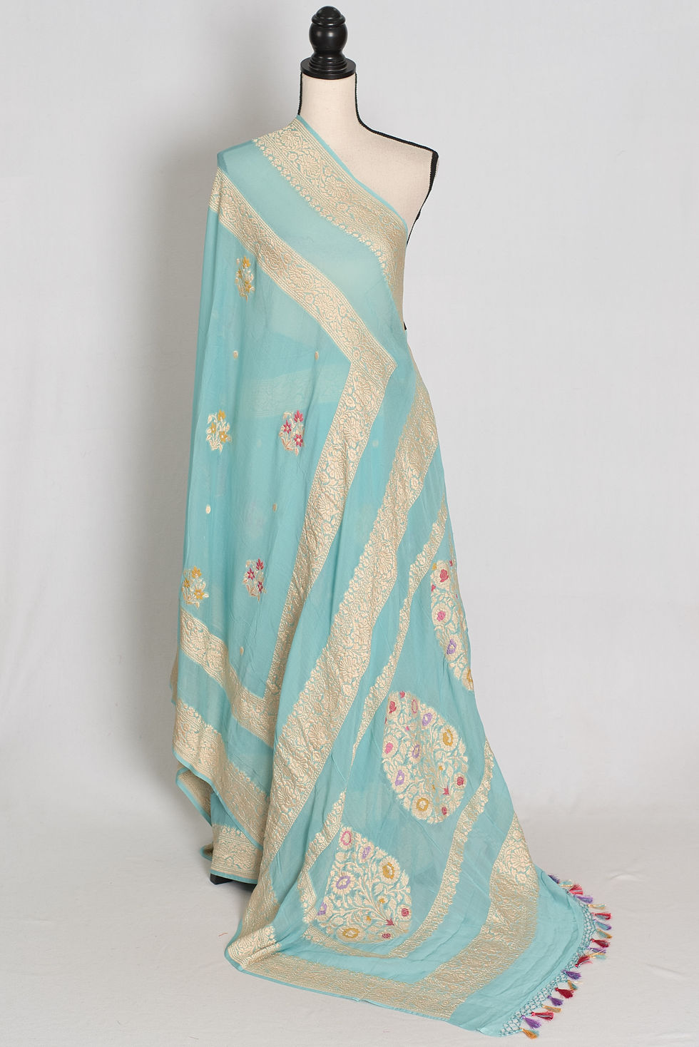 Sky blue handwoven pure Khaddi georgette silk Banarasi saree with gold zari meenakari bootis, ornate pallu, and tassels.
