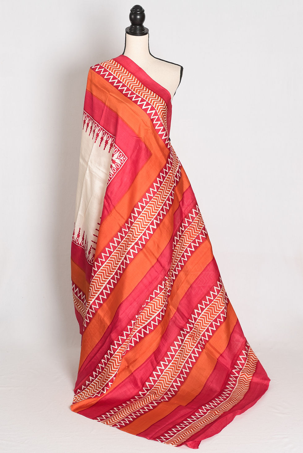 Off-white and red hand block printed Murshidabad pure silk saree featuring geometric chevron patterns, temple border motifs.