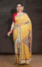 Full view of a beige Pure Tussar Silk saree with intricate multi-color Kantha embroidery on a mannequin.
