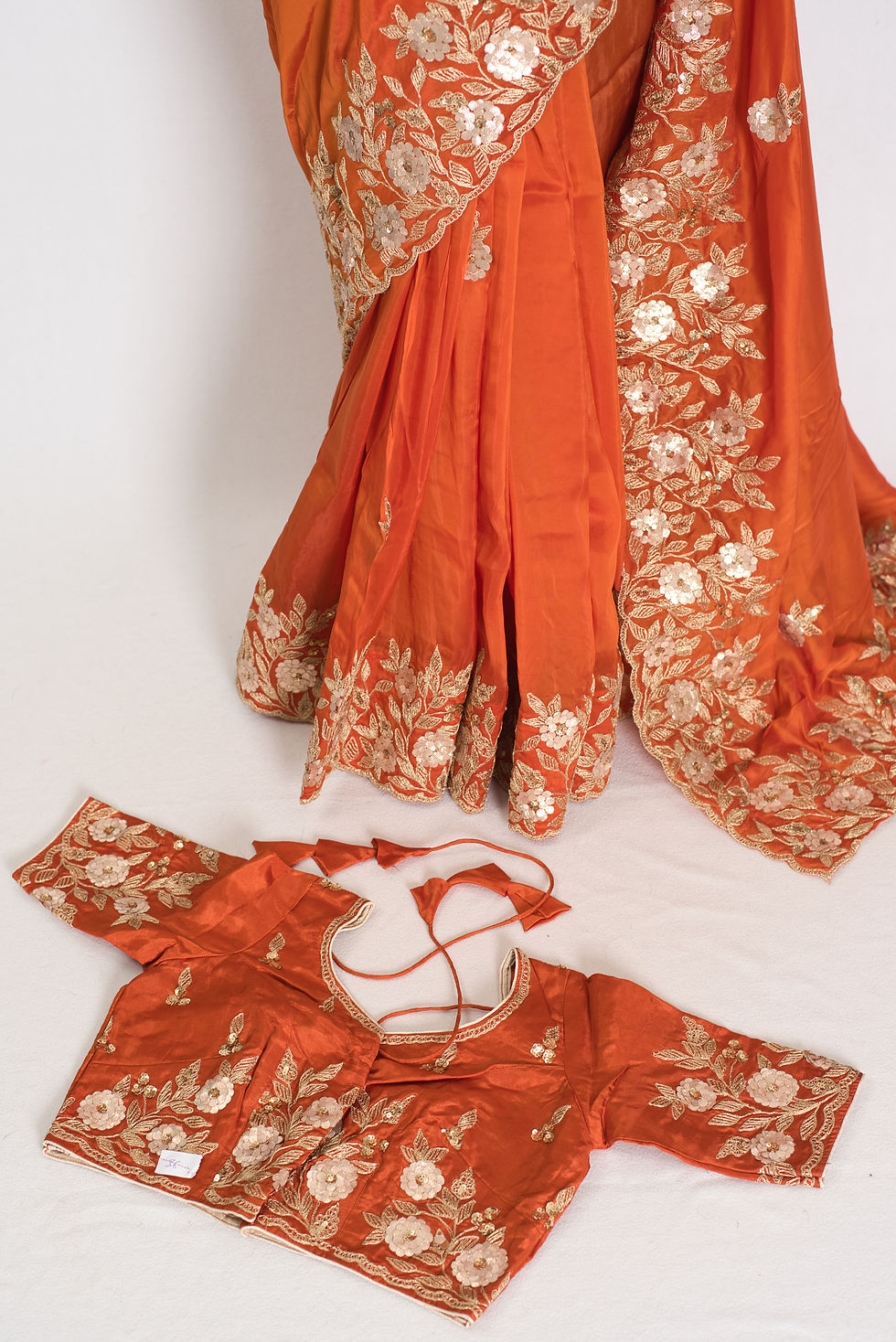 Thumbnail: Suman rusty orange soft flowy organza silk saree with gold Gota Patti hand-embroidery and size 36 stitched blouse.