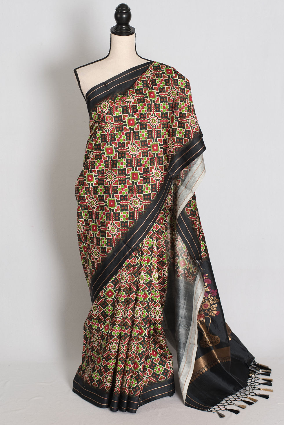 Black and gold contemporary banarasi katan silk saree featuring geometric ikkat print on a full mannequin drape.