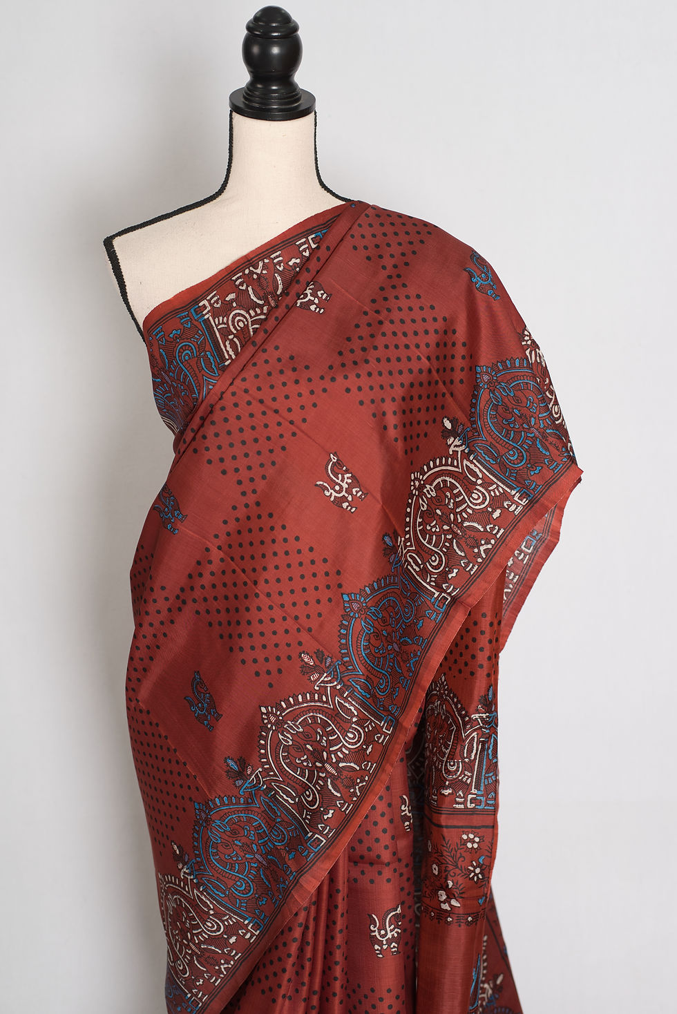 Thumbnail: Brown Bishnupuri silk saree with hand block printed geometric borders and folk motifs draped on a mannequin.
