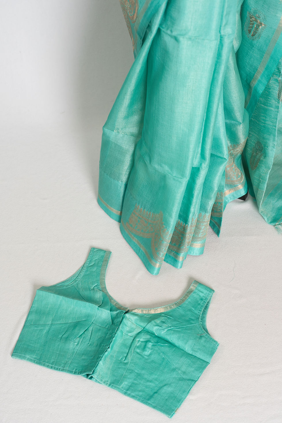 Sea green Bengal Tussar Banarasi silk saree featuring gold zari scalloped border and matching sleeveless stitched blouse.