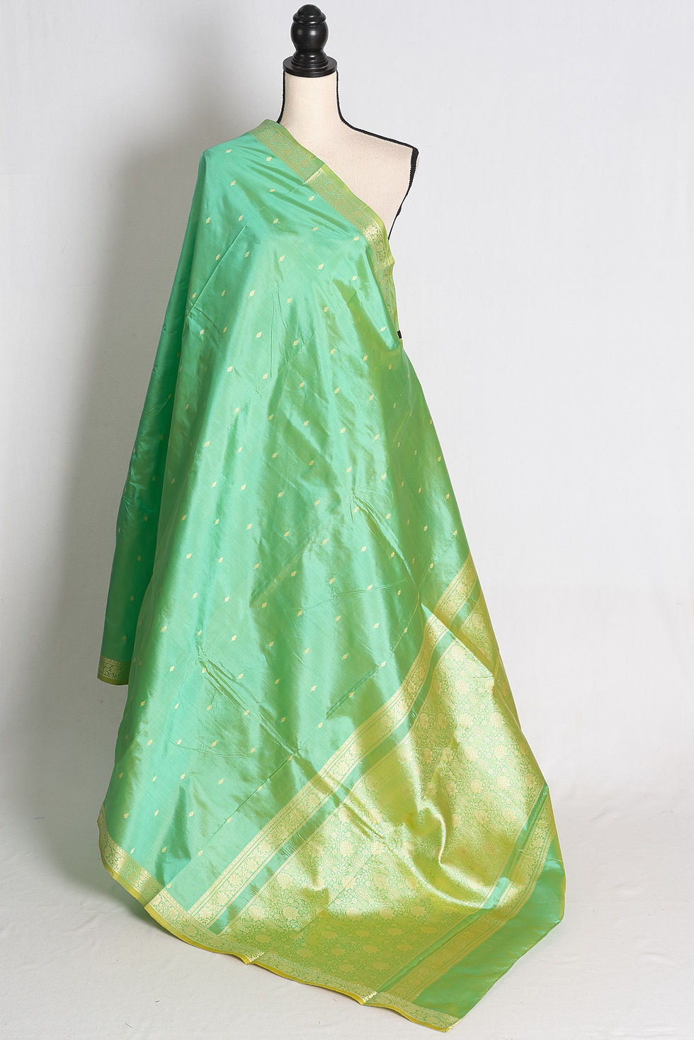 Green and Gold Lightweight Katan Banarasi Silk Saree draped elegantly on a mannequin.