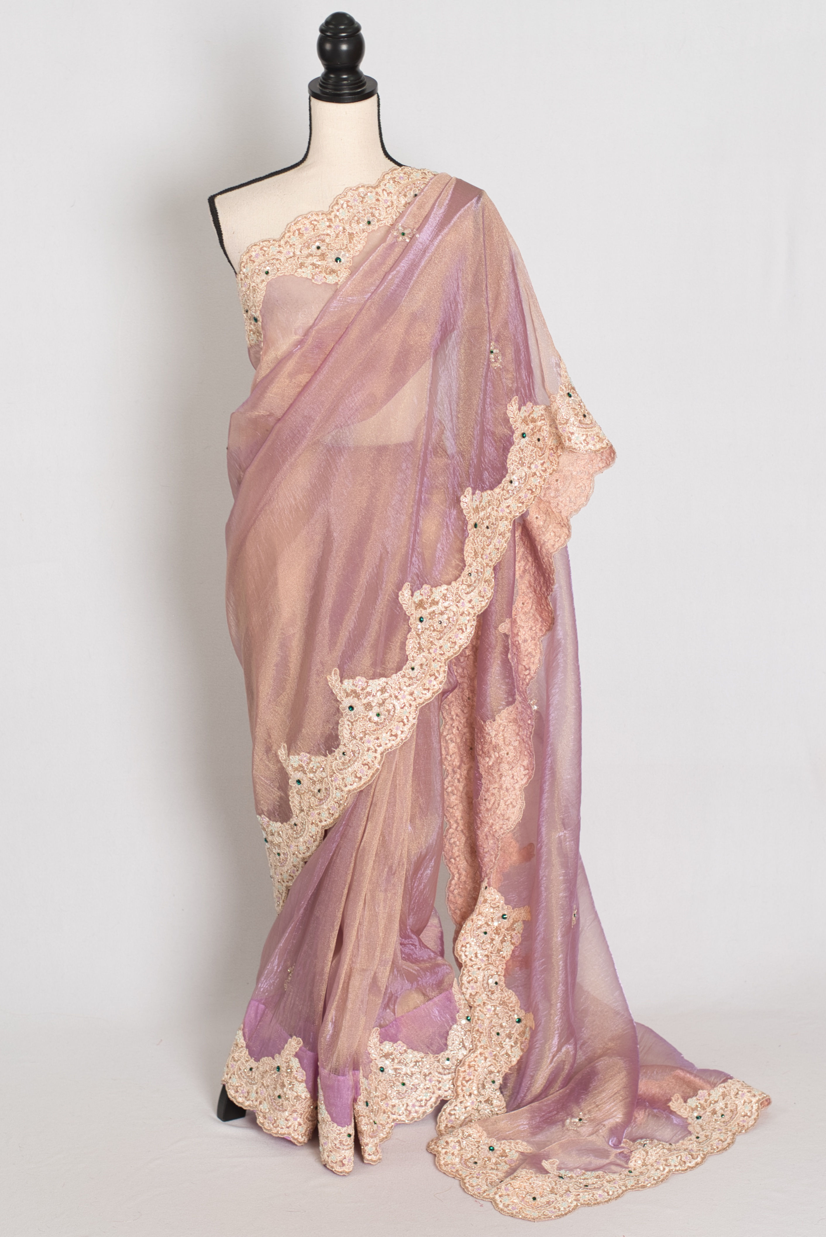 Front full-length view of the lavender soft tissue partywear saree draped on a mannequin.