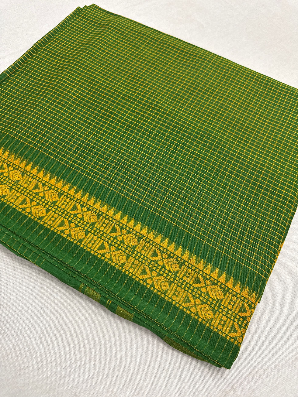 Green and yellow micro-checks pure cotton Bengal handloom Dhaniakhali saree with a yellow woven border.