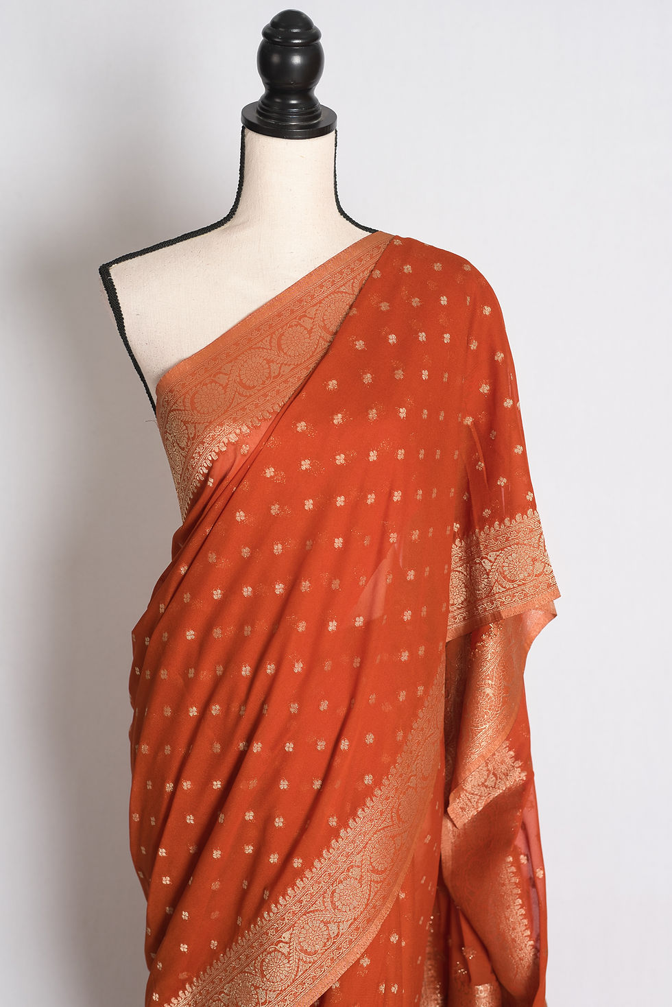 Thumbnail: Rust Brown Semi Georgette Banarasi Saree draped elegantly on a mannequin showcasing its rich gold zari borders and pallu.
