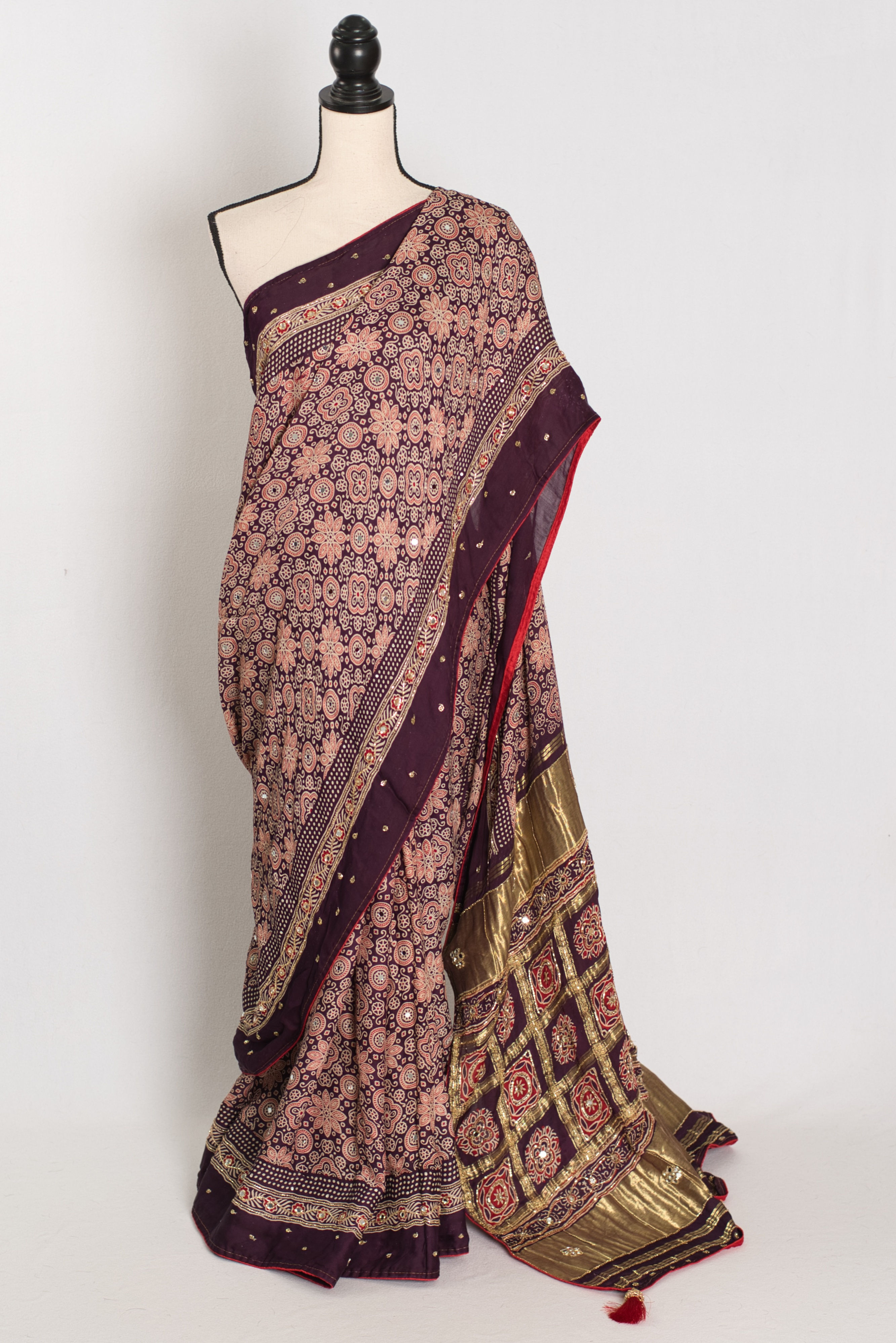 Sarah deep purple modal silk Ajrakh saree with Gharchola pallu and hand-embroidered mirror and cut dana work.