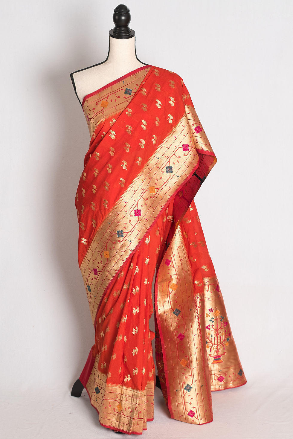 Orange and Gold Semi Silk Paithani Saree draped elegantly on a mannequin showcasing its rich gold zari borders.
