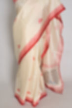 Thumbnail: Cream and red semi silk Durga Puja saree on a mannequin featuring a printed red border with Goddess Durga's face in the pallu