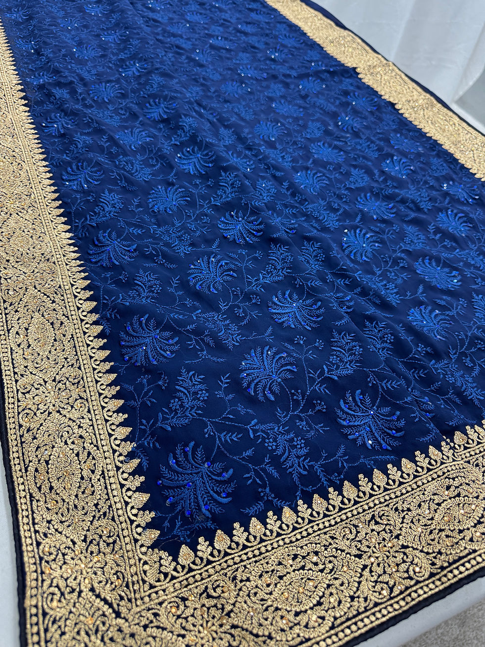 Full view of the midnight blue georgette partywear saree laid flat, highlighting the dense blue floral embroidery.