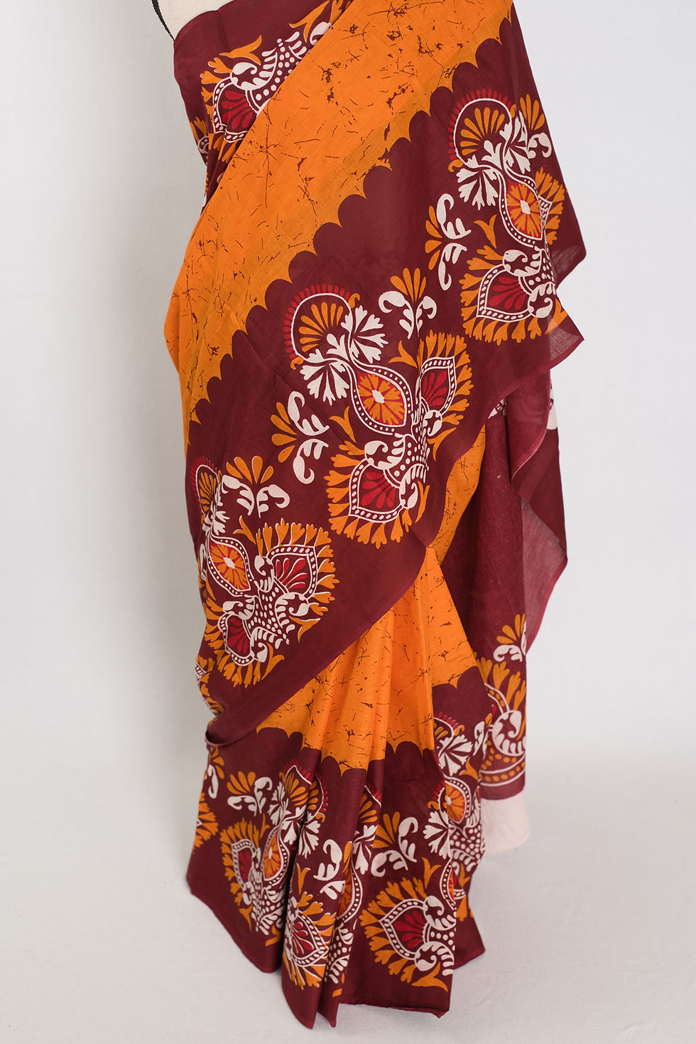 Thumbnail: Orange and red Mulmul cotton saree with intricate Batik wax-resist prints (Trina Collection).