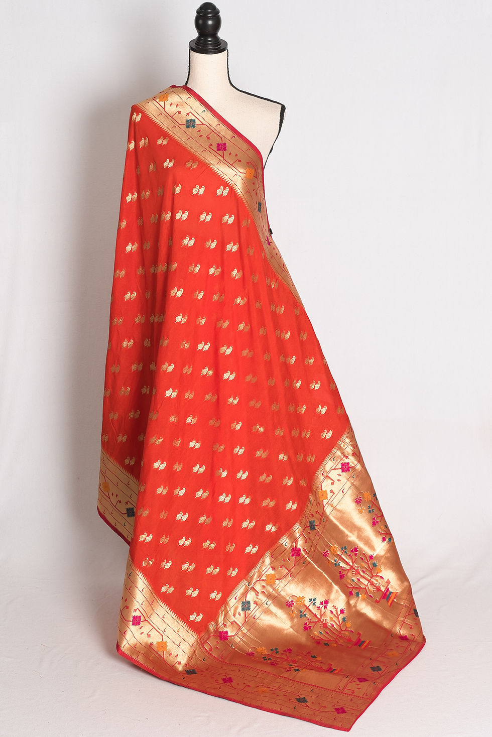 Orange and Gold Semi Silk Paithani Saree draped elegantly on a mannequin showcasing its rich gold zari borders.