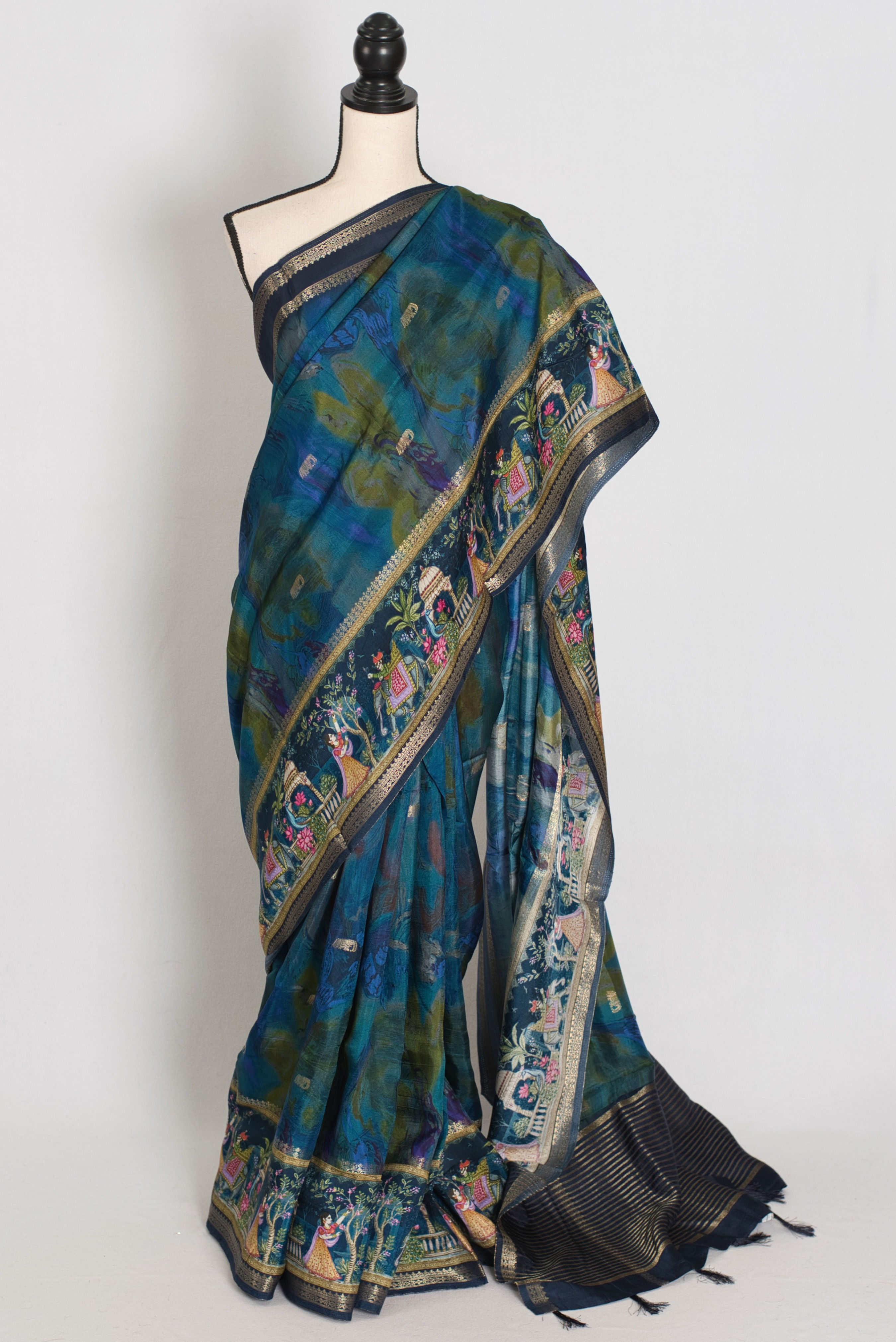 Royal blue Dola silk Banarasi saree featuring digital printed traditional figure designs and a woven gold zari border.