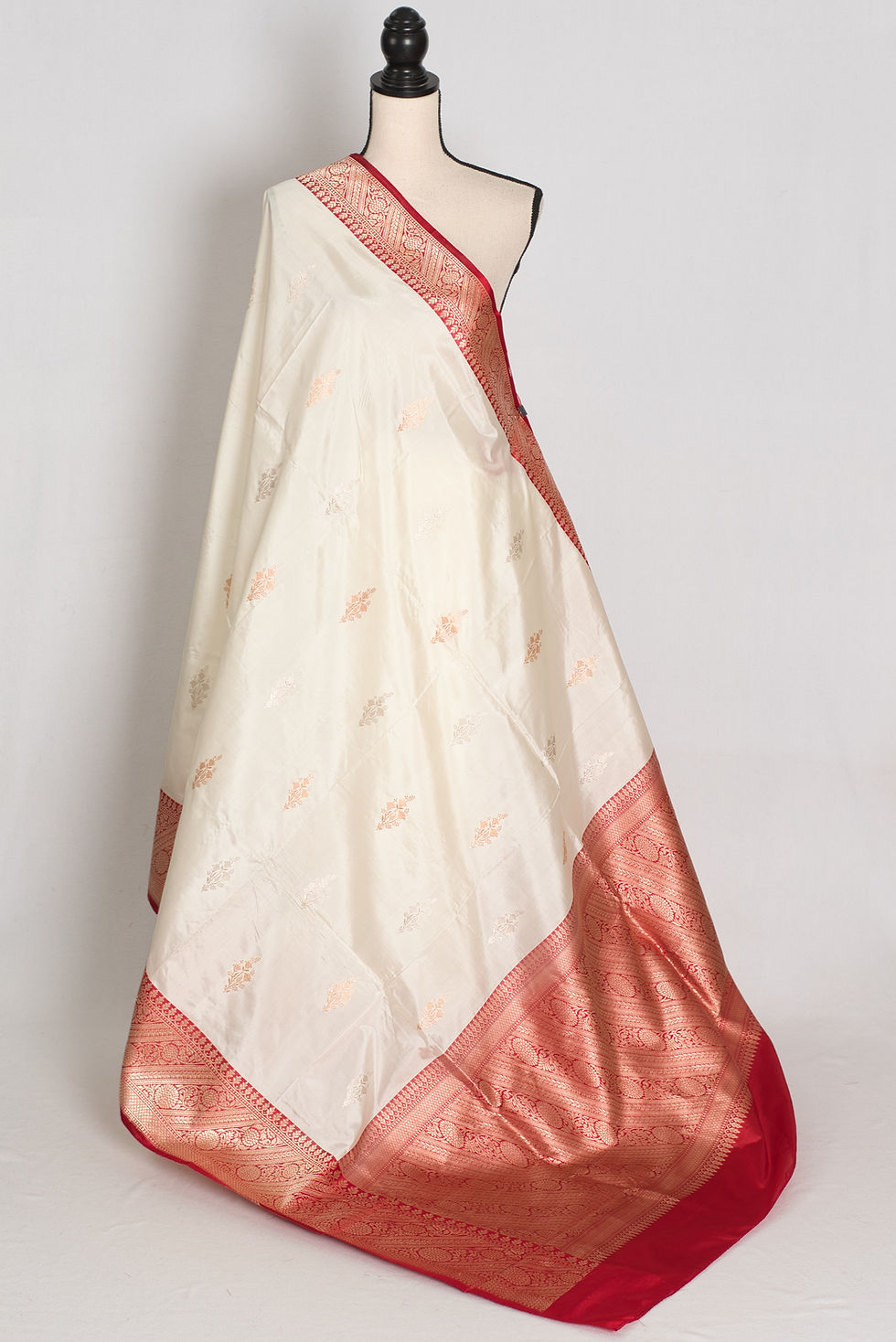 Off-white and red handwoven pure silk Banarasi saree with silver zari bootis, rich red zari border, and matching blouse piece