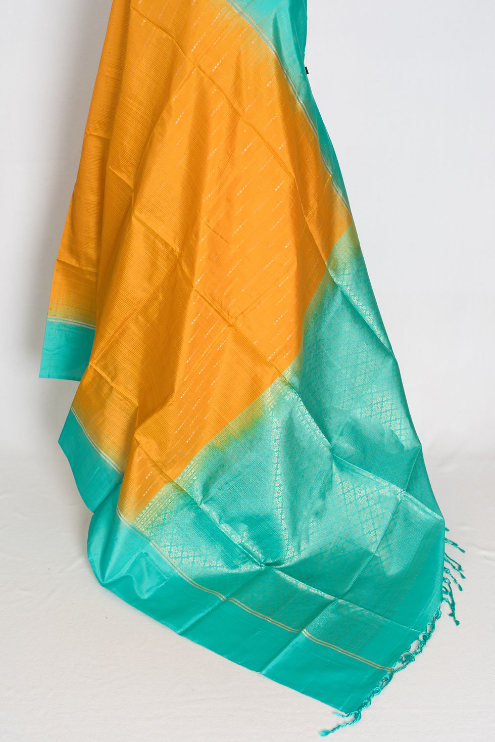 Thumbnail: Golden yellow lightweight Kanjivaram silk saree featuring fine zari dashes, a solid sea green border, sea green brocade pallu