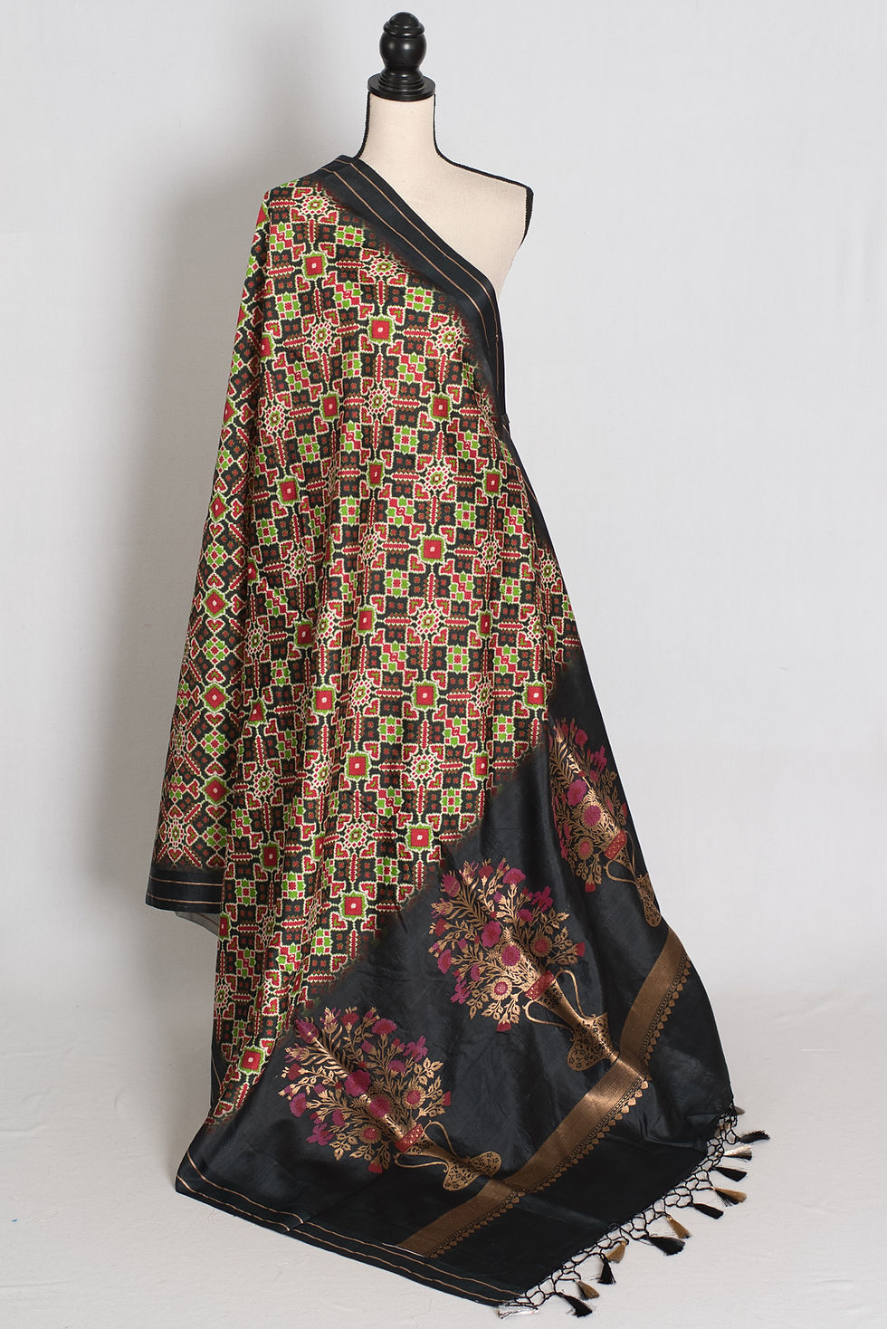 Black and gold contemporary banarasi katan silk saree featuring geometric ikkat print on a full mannequin drape.